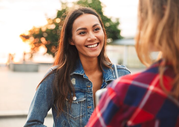 Close up of a smiling asian woman talking to her girl | Vadym Drobot Close up of a smiling asian woman talking to her girl | Vadym Drobot