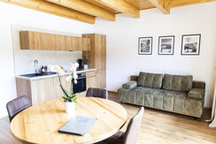 Wohnzimmer mit Küche, Couch und Sitzplätze