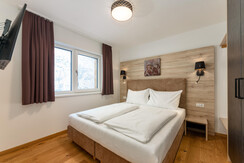 Bedroom with double bed and TV