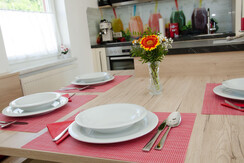 Set table with a view of the kitchen