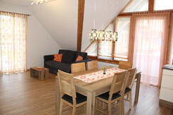 Dining table with couch behind it 