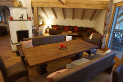 Dining table, tiled oven and sitting area