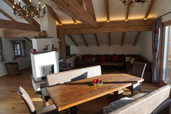 Dining table, tiled stove and sitting area
