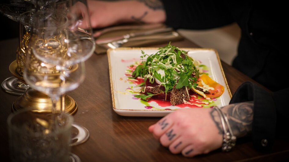 Ein kunstvoll angerichteter Teller mit frischen Zutaten.