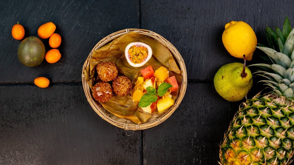 Bunter Obstteller mit Snacks in einem Korb.